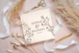 overhead flat lay of wildflower engraved wedding guest book on white background