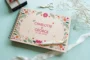 floral engraved wedding guest book open showing thick 160gsm white pages for guest messages
