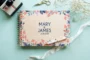 floral engraved wedding guest book open showing thick 160gsm white pages for guest messages