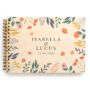 Bold botanical wedding guest book with full-colour UV-printed wooden cover, shown open with spiral binding