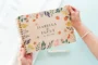 Bold botanical wooden wedding guest book internal page layout showing lined pages for guest messages