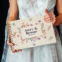 Wildflower border wedding guest book square UV-printed cover close-up with vibrant colour floral border design