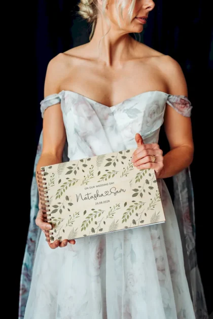 personalised wooden wedding guest book lying flat showing landscape format and copper spiral wire binding