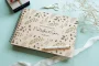 personalised botanical wedding guest book cover detail with laser-engraved floral design