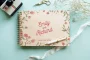 personalised wooden wedding guest book lying flat showing landscape format and copper spiral wire binding