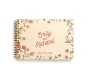close-up of floral engraved wooden wedding guest book cover showing engraved names and date
