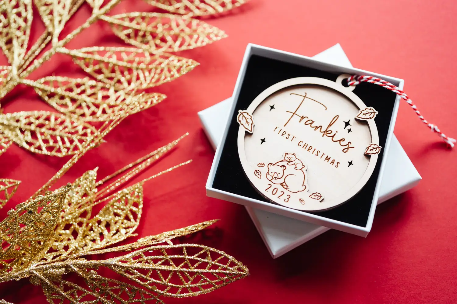 Baby's First Christmas Mama Bear Bauble shown with festive decorations
