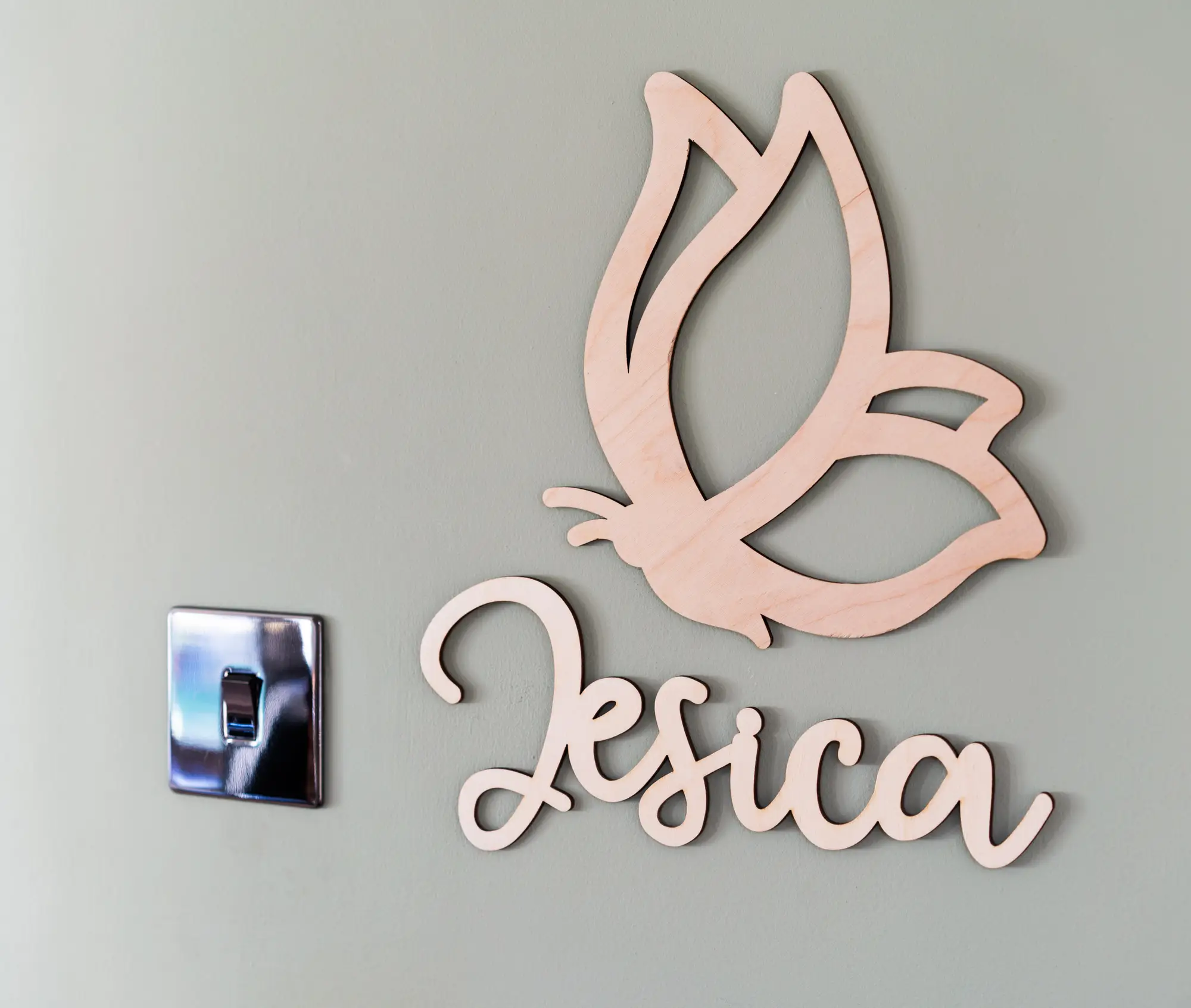 Butterfly kids room sign displayed on a shelf