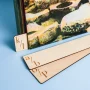 Double-sided engraved wooden vinyl record dividers standing upright in an Ikea Kallax shelf unit