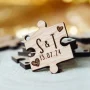 Personalised wooden puzzle piece wedding favours with oak veneer finish, engraved with couple's names and wedding date
