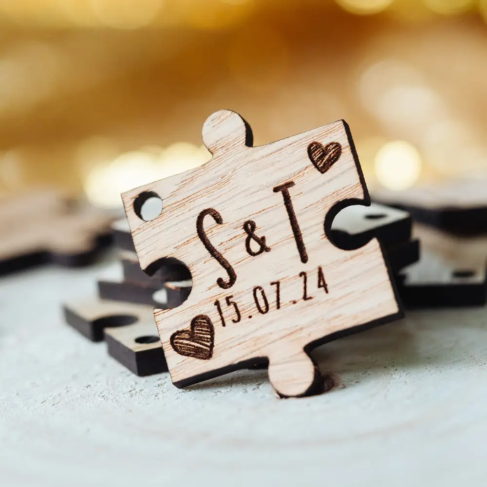 Personalised wooden puzzle piece wedding favours with oak veneer finish, engraved with couple's names and wedding date