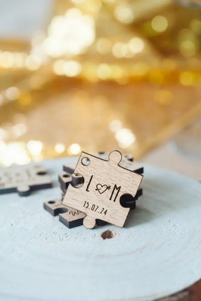 Close-up of an engraved puzzle piece wedding favour