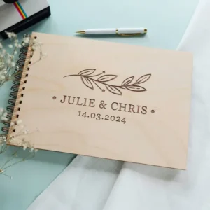 Customer holding personalised wooden wedding guest book from CluckingBelle showing engraved cover detail