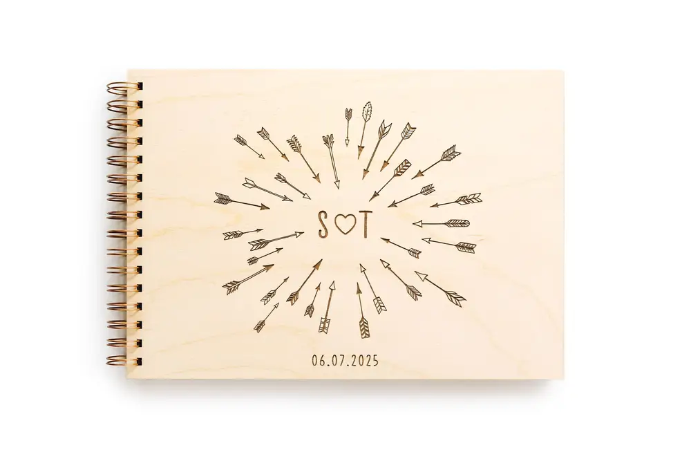 31-05-2023-13-22-20.webp Close-up of the cupid's arrow & love heart guest book engraved cover detail