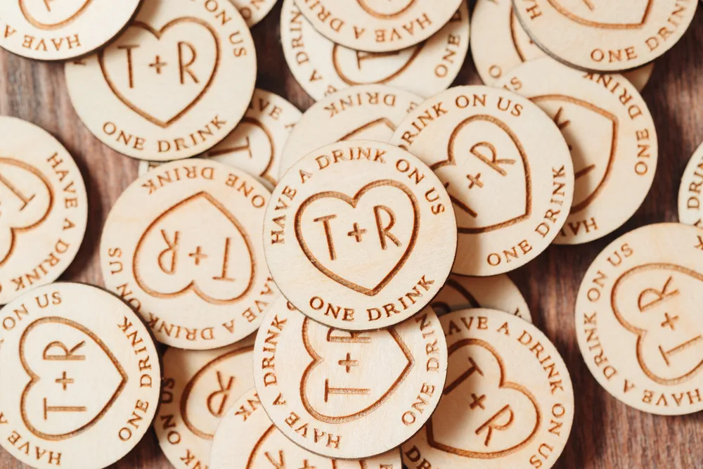 Timeless Love Heart Drink Tokens held in hand showing engraved detail