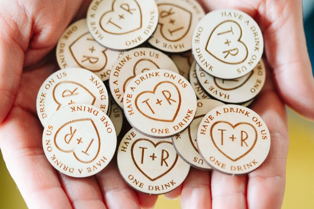 Timeless Love Heart Drink Tokens displayed on a rustic wooden surface