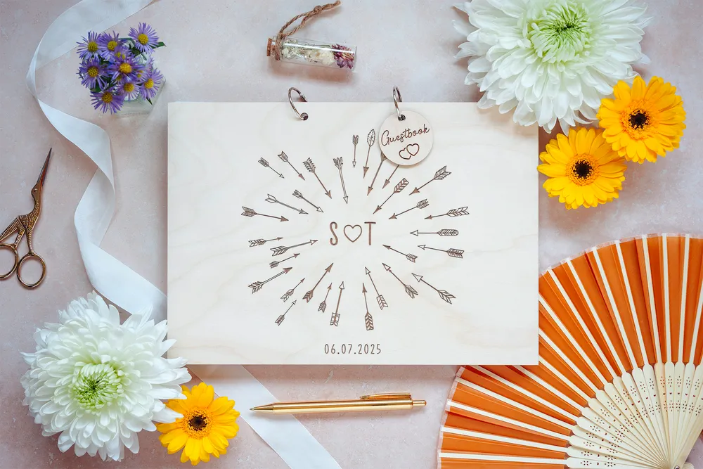 Close-up of the cupid's arrow wedding guest book engraved cover detail
