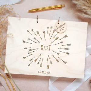 Close-up of laser-engraved wooden wedding guest book cover with couple's names and wedding date