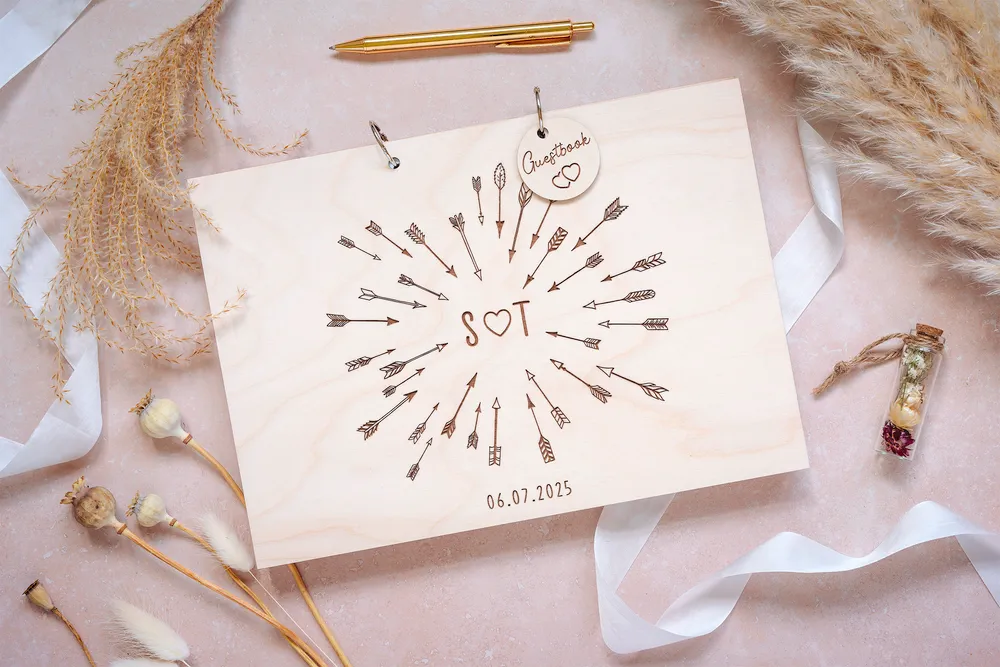 Personalised cupid's arrow wedding guest book with couple's names and date