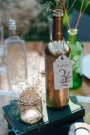 Flower Design Bottle Table Numbers 5 Flower Design Bottle Table Numbers displayed on a wedding reception table