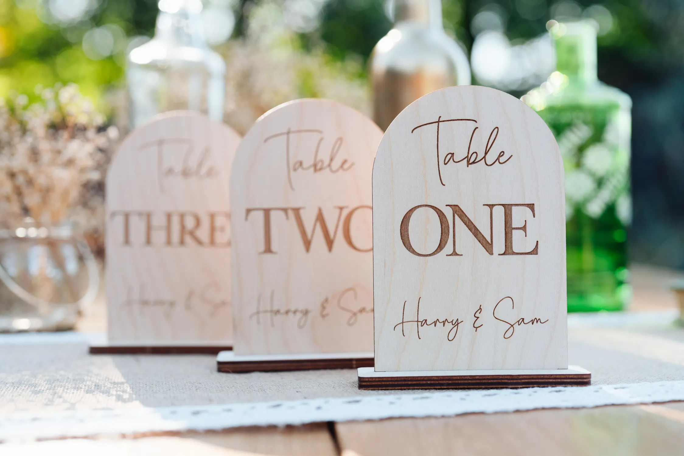 Laser-engraved oak personalised wedding table numbers with natural wood grain