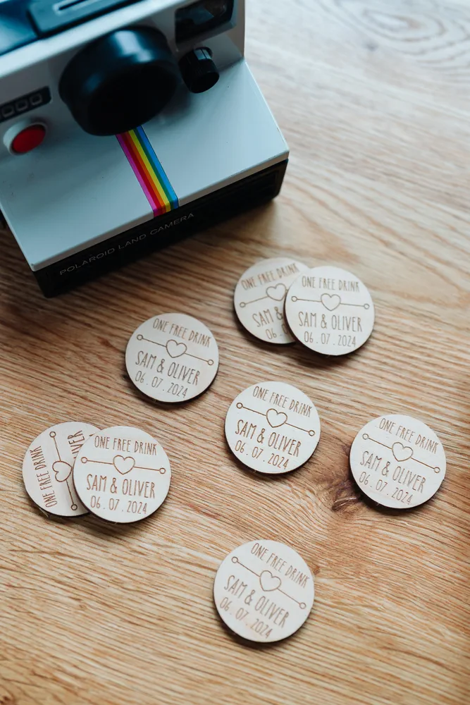 Boho Love Heart Drink Tokens held in hand showing engraved detail