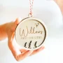 Laser-engraved wooden child's first christmas bauble with ribbon