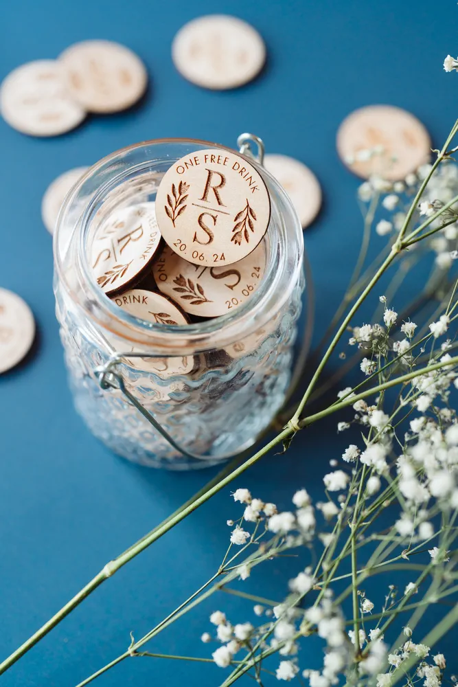 Floral Initials Drink Tokens held in hand showing engraved detail