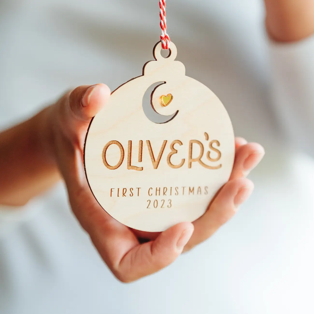Baby's First Christmas Moon & Star Bauble shown with festive decorations