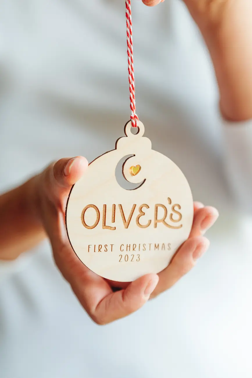 Close-up of the baby's first christmas moon & star bauble engraved detail