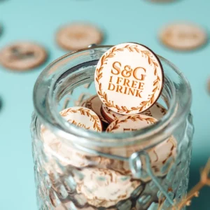 Personalised wooden wedding bar drink token with engraved bar scene design handcrafted in Norwich UK