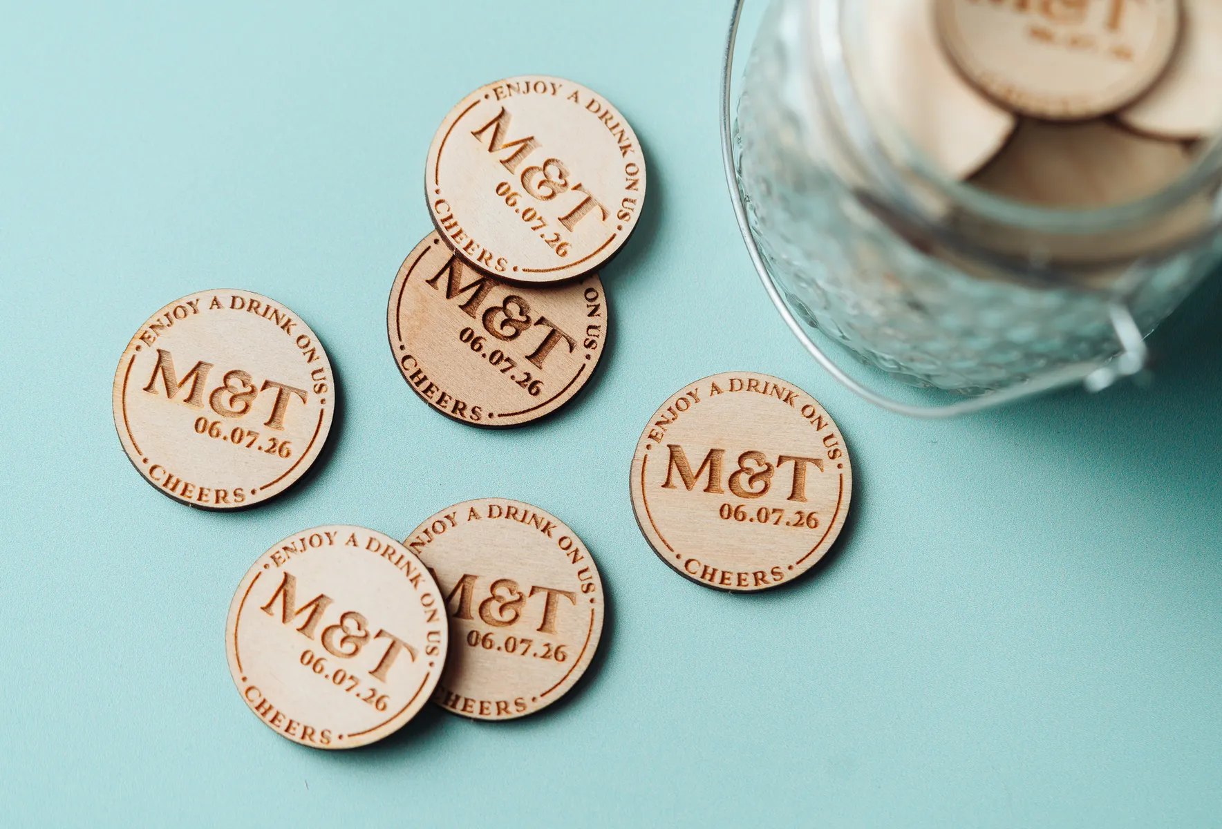 Rustic Charm Drink Tokens held in hand showing engraved detail
