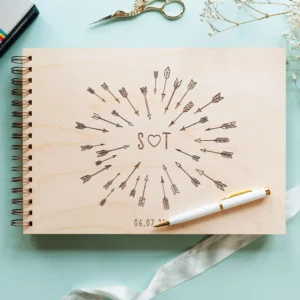 Customer review photo showing personalised Cupid's arrow wooden wedding guest book from CluckingBelle