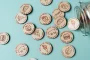 Personalised Food Tokens held in hand showing engraved detail