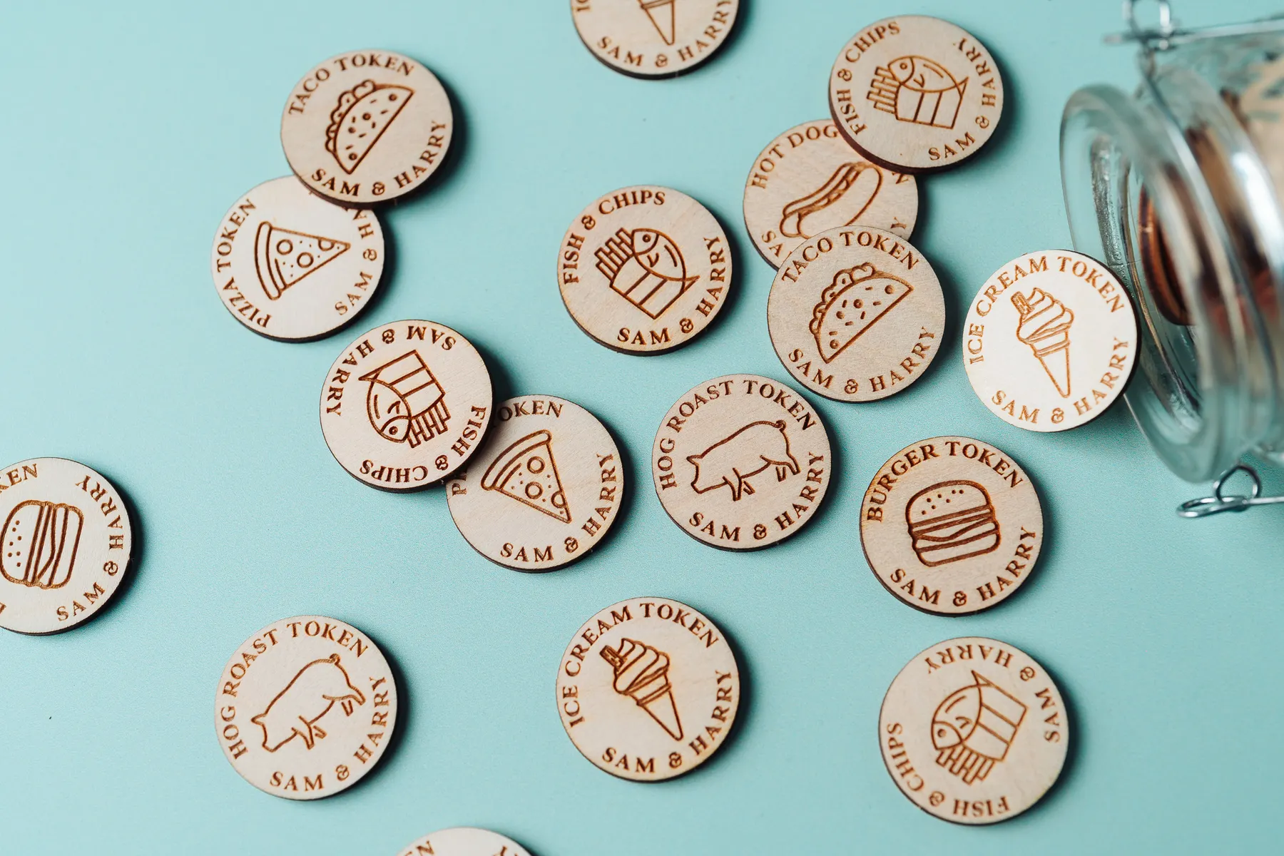 Personalised Food Tokens held in hand showing engraved detail