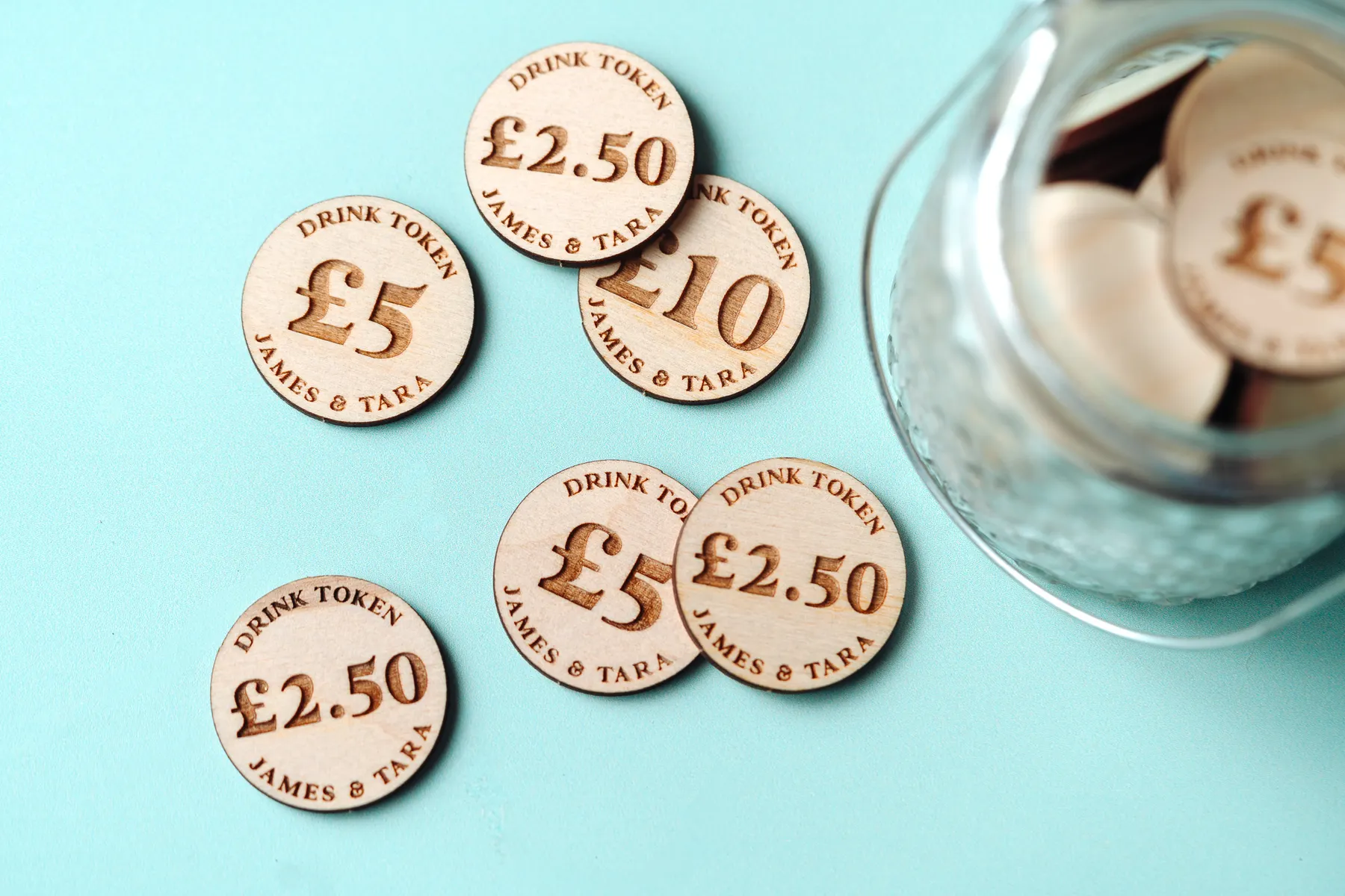 Cash Value Drink Tokens held in hand showing engraved detail