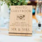 Camera and film photo guestbook sign engraved on oak for wedding receptions