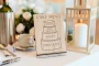 Rustic Cake Flavours Sign displayed on an easel at a wedding reception