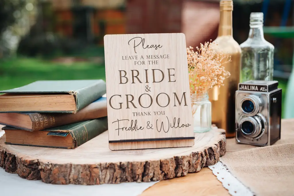 Leave A Message Wedding Sign displayed on an easel at a wedding reception