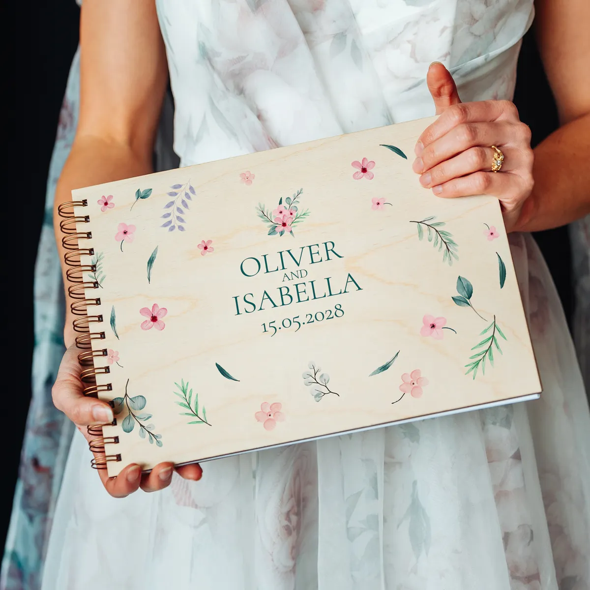 personalised wooden wedding guest book lying flat showing landscape format and copper spiral wire binding
