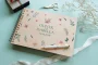 close-up of engraved wooden wedding guest book cover showing engraved names and date