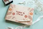 Wildflower border wooden wedding guest book showing A4 and A5 size options side by side with spiral binding