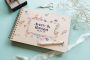 Wildflower border wedding guest book landscape view showing full-colour printed wooden cover and wire spiral binding