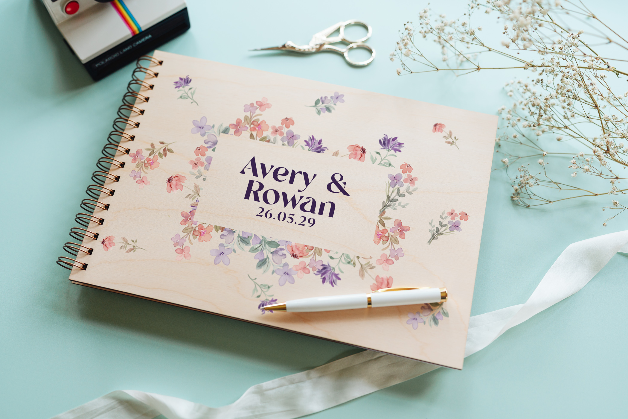 Wildflower border wedding guest book landscape view showing full-colour printed wooden cover and wire spiral binding