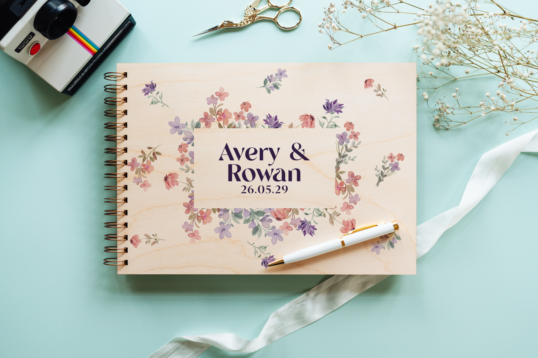 Wildflower border wooden wedding guest book open showing personalised couple names on colour-printed wooden cover