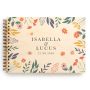 Bold botanical wedding guest book with full-colour UV-printed wooden cover, shown open with spiral binding