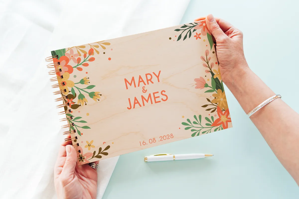 floral engraved wedding guest book cover with personalised couple names and wedding date