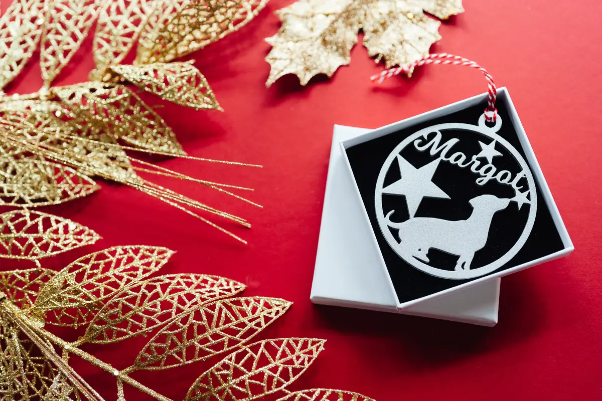 Laser-engraved wooden personalised pet bauble with ribbon