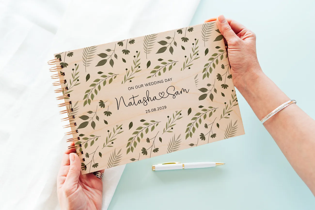 botanical personalised wooden wedding guest book with spiral wire binding and personalised wooden cover