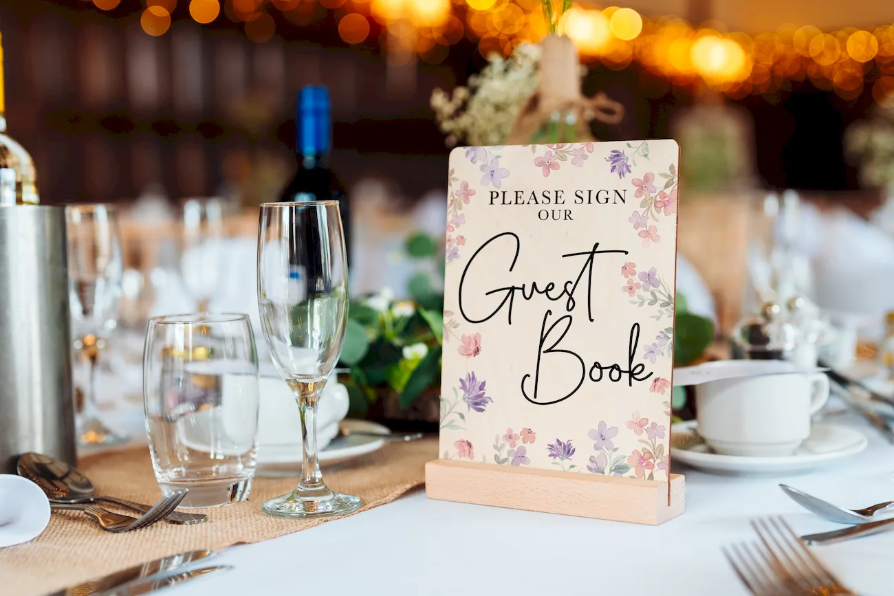 personalised wooden wedding guest book propped upright showing full cover design and binding